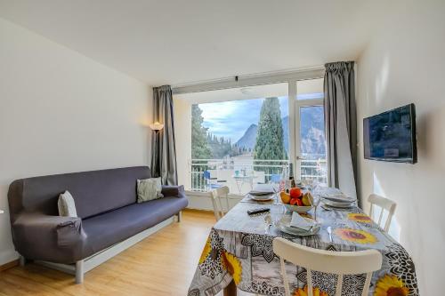 a living room with a table and a couch at Il Piccolo Nido - Happy Rentals in Riva del Garda