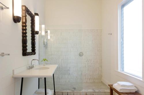 a white bathroom with a sink and a shower at Ridley House - Key West Historic Inns in Key West