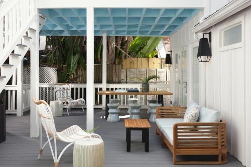 a porch with a couch and chairs and a table at Ridley House - Key West Historic Inns in Key West