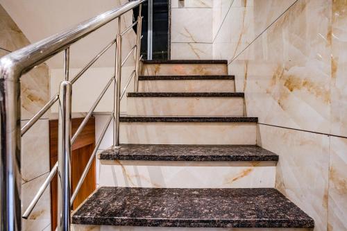 a set of stairs in a building with marble at Hotel Czar Inn - Vashi Navi Mumbai in Navi Mumbai
