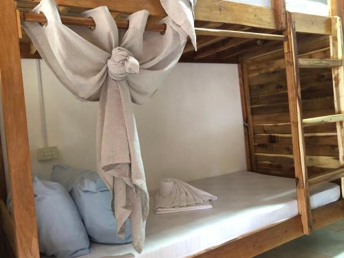 a bunk bed with a towel hanging off of it at Hello Hostel in San Vicente