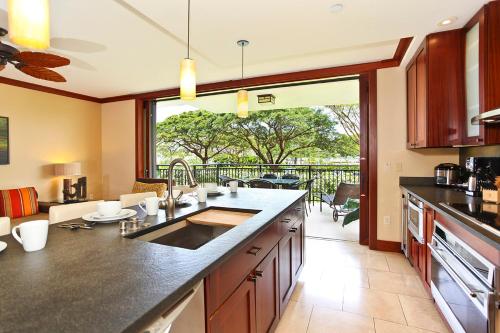 a kitchen with a large counter and a large window at Ko Olina Beach Villas B204 in Kapolei