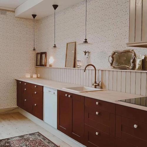 a kitchen with a sink and a counter top at Villa Åmmeberg in Åmmeberg