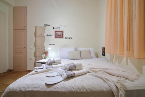 a bedroom with a white bed with towels on it at Villa Spilies Kythira in Kýthira