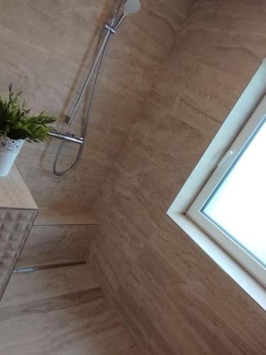 a shower in a bathroom with a wooden floor at Wohnung in Werne in Werne an der Lippe