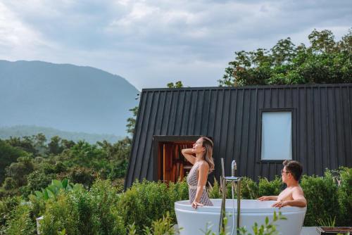 a man and a woman standing in a bath tub at The CAMPIAN in Chiang Mai