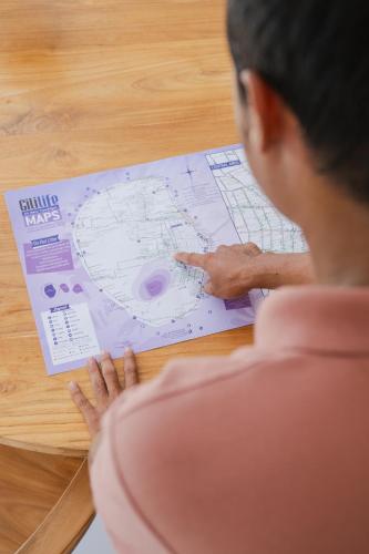 a woman is looking at a plan on a table at Gili Boho Villas - Aesthetic Private Pool Villas in Gili Trawangan