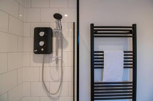 a shower with a shower head in a bathroom at Comfortable stay at 3 BR home, prime location in Sunderland