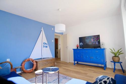 - un salon avec une télévision et une commode bleue dans l'établissement Captain's home ****, à Opatija