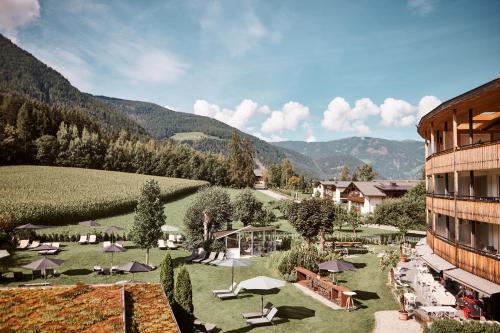 a view of a resort with mountains in the background at Hotel Petrus in Brunico