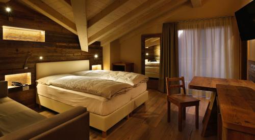 Ένα ή περισσότερα κρεβάτια σε δωμάτιο στο Albergo Garnì Antico Mas del Medico
