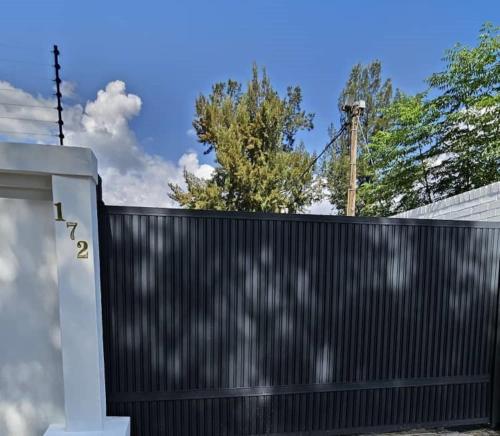 a black fence in front of a house at DBrite in Pretoria