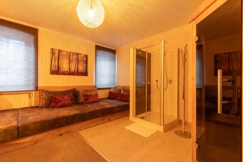 a living room with a couch and a shower at Appartements Feroli in Dienten am Hochkönig