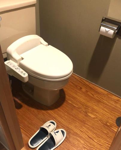 a pair of slippers in a bathroom with a toilet at Breezbay Seaside Resort Matsushima in Matsushima