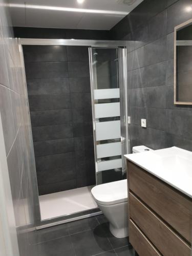 La salle de bains est pourvue d'une douche, de toilettes et d'un lavabo. dans l'établissement Quintana-Alcalá Apartments, à Madrid