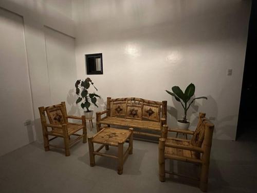 a room with chairs and a couch and a table at Faith Street Airbnb in Plaridel