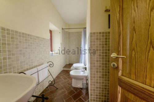 a bathroom with a white toilet and a sink at San Gennaro Castello in San Gennaro
