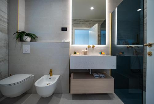 a bathroom with a sink and a toilet and a sink at Cascade Luxury Apartments in Dubrovnik