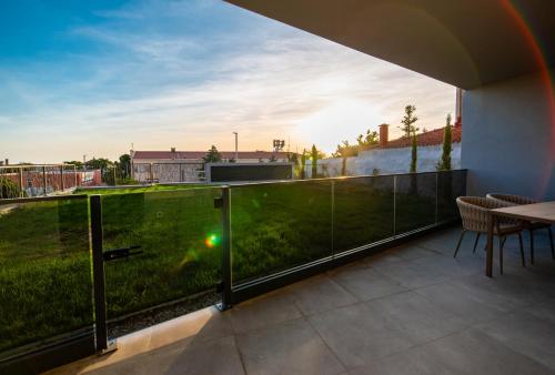 a balcony with a view of a green field at Cascade Luxury Apartments in Dubrovnik