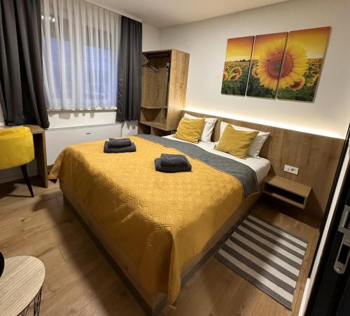 a bedroom with a bed with two towels on it at RoomSB in Slavonski Brod