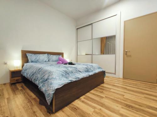 a bedroom with a bed with a stuffed animal on it at SoulHealingPlace Galacity 2BR 3Bed Apartment in Kuching
