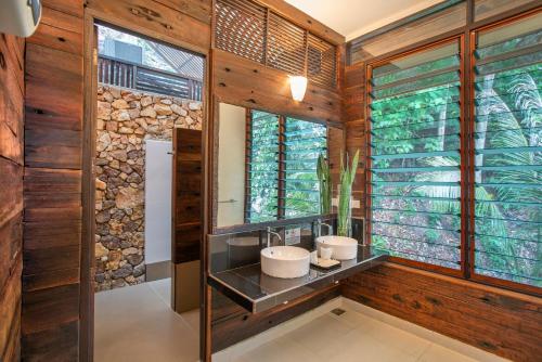 a bathroom with two sinks and a mirror at Rawa Island Resort in Mersing