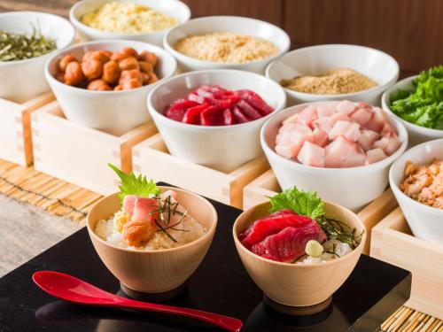 a table with bowls of different types of food at Hotel JAL City Sapporo Nakajima Park in Sapporo