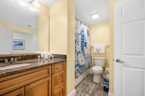 a bathroom with a sink and a toilet at Beachfront Luxury Villa Ocean Walk Resort Daytona in Daytona Beach