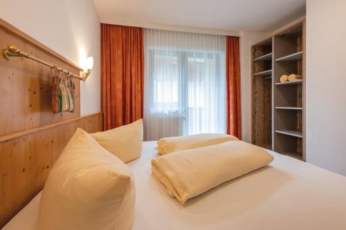 two pillows sitting on a bed in a room at Apart&Chalet Chiara in Neustift im Stubaital
