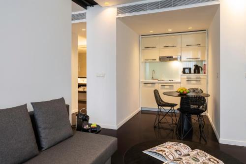 a living room with a couch and a table at B-aparthotel Regent in Brussels