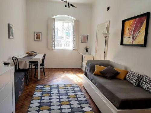 a living room with a couch and a table at Cosy condo in the heart of the Upper town Zagreb in Zagreb