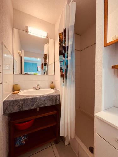 une salle de bain avec un lavabo et une douche dans l'établissement AZUREVA II Joli 2 pièces cabine piscine Richelieu Cap d'Agde, au Cap d'Agde