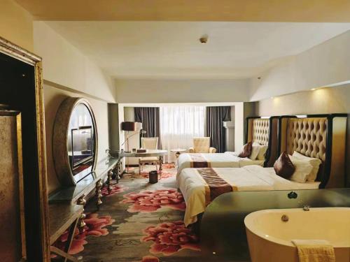 a hotel room with two beds and a bath tub at 广州克莱顿酒店 Clayton Hotel Pazhou Exhibition Center in Guangzhou
