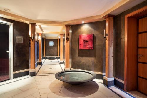 a hallway with a large glass bowl on the wall at Hotel Adula in Flims