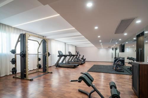 a gym with a row of treadmills and machines at Holiday Inn Express Xiamen Lushan -Shopping Center by IHG in Xiamen