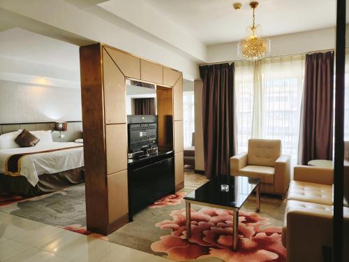 a hotel room with a bed and a living room at 广州克莱顿酒店 Clayton Hotel Pazhou Exhibition Center in Guangzhou