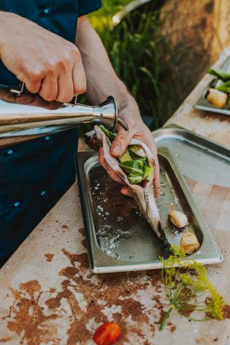 a person is preparing a plate of food on a table at Resort Český les in Bělá nad Radbuzou
