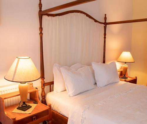a bedroom with a bed with white sheets and pillows at Dar Yessine Boutique Hôtel in Sousse