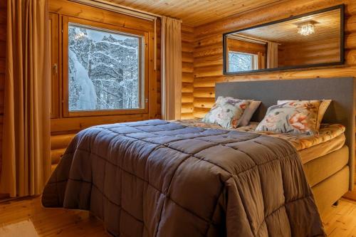 1 dormitorio con 1 cama en una cabaña de madera en Villa Äkäsjoensuu, en Äkäslompolo