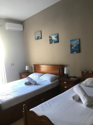 a bedroom with two beds with towels on them at Villa Castle View in Shkodër