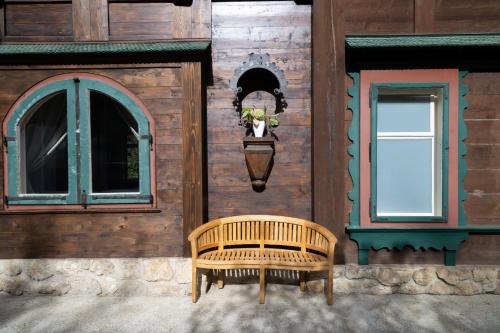 a wooden building with a bench and a window at Villa Schönthaler in Semmering
