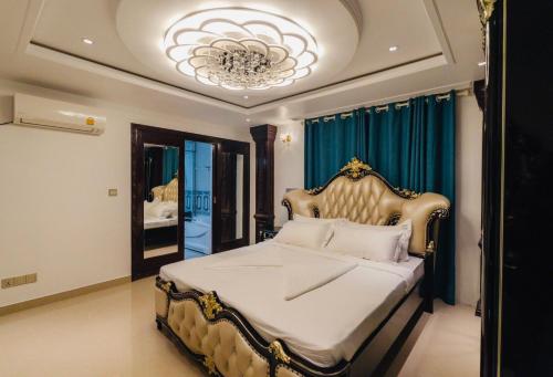 a bedroom with a large bed with a chandelier at Starry View in Hulhumale