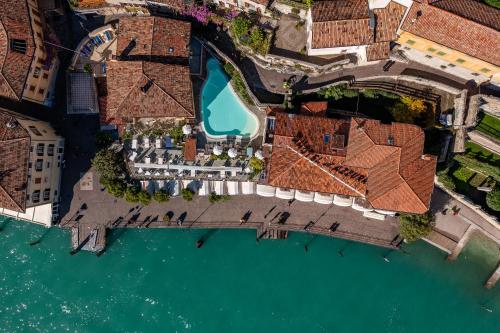 an aerial view of a resort on the water at Hotel all'Azzurro in Limone sul Garda