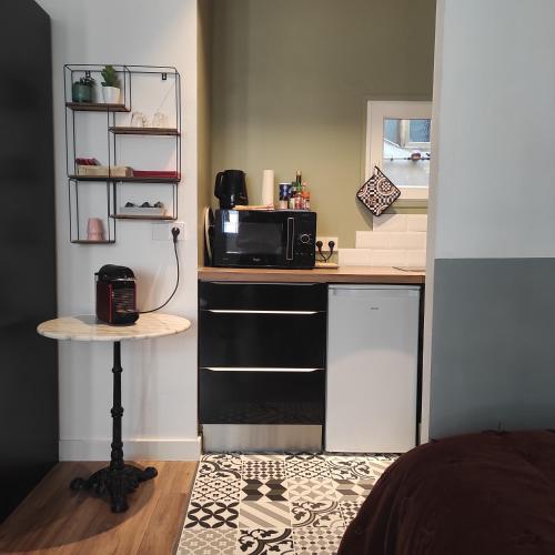 une petite cuisine avec un four micro-ondes sur un comptoir dans l'établissement Grand studio confortable au coeur de NICE, à Nice