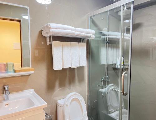 a bathroom with a shower and a toilet and a sink at Dreamy Sunset Bay in Manila