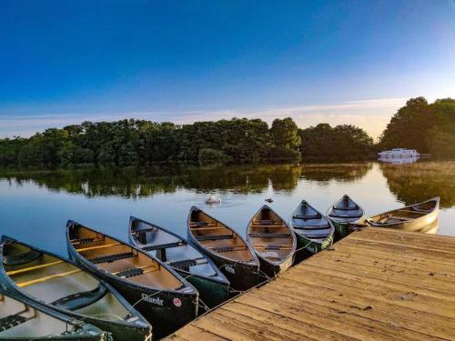 a group of canoes lined up next to a dock at Chalet 145, Hemsby - Two bed chalet, sleeps 5, pet friendly, bed linen and towels included and close to beach! in Great Yarmouth