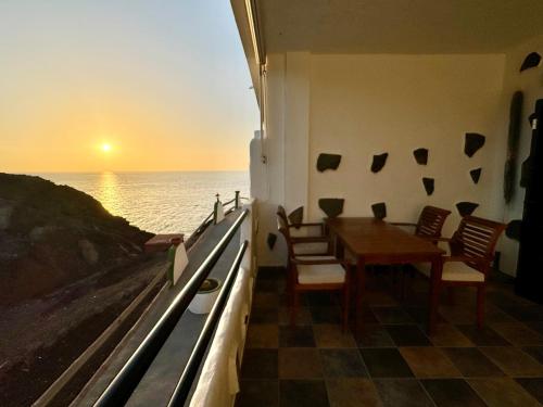 a dining room with a table and a view of the ocean at La Gloria del Norte in Las Palmas de Gran Canaria