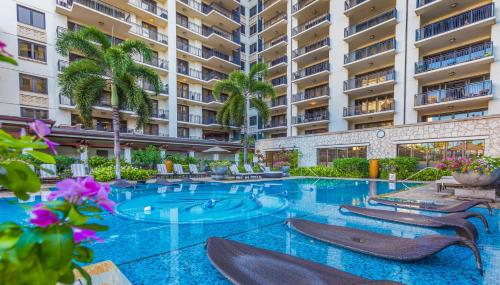 a swimming pool in the middle of a building at Ko Olina Beach Villas O1006 in Kapolei
