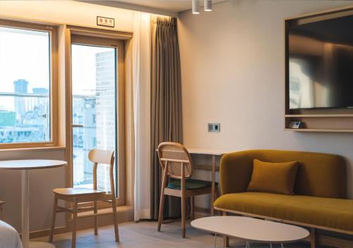 a living room with a couch and a table at Nampo Ocean2Heaven Hotel& Spa in Busan