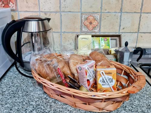 a basket of bread on a counter next to a coffee pot at B&B Camera delle Camelie in Palestrina